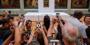 crowd taking photos of mona lisa painting